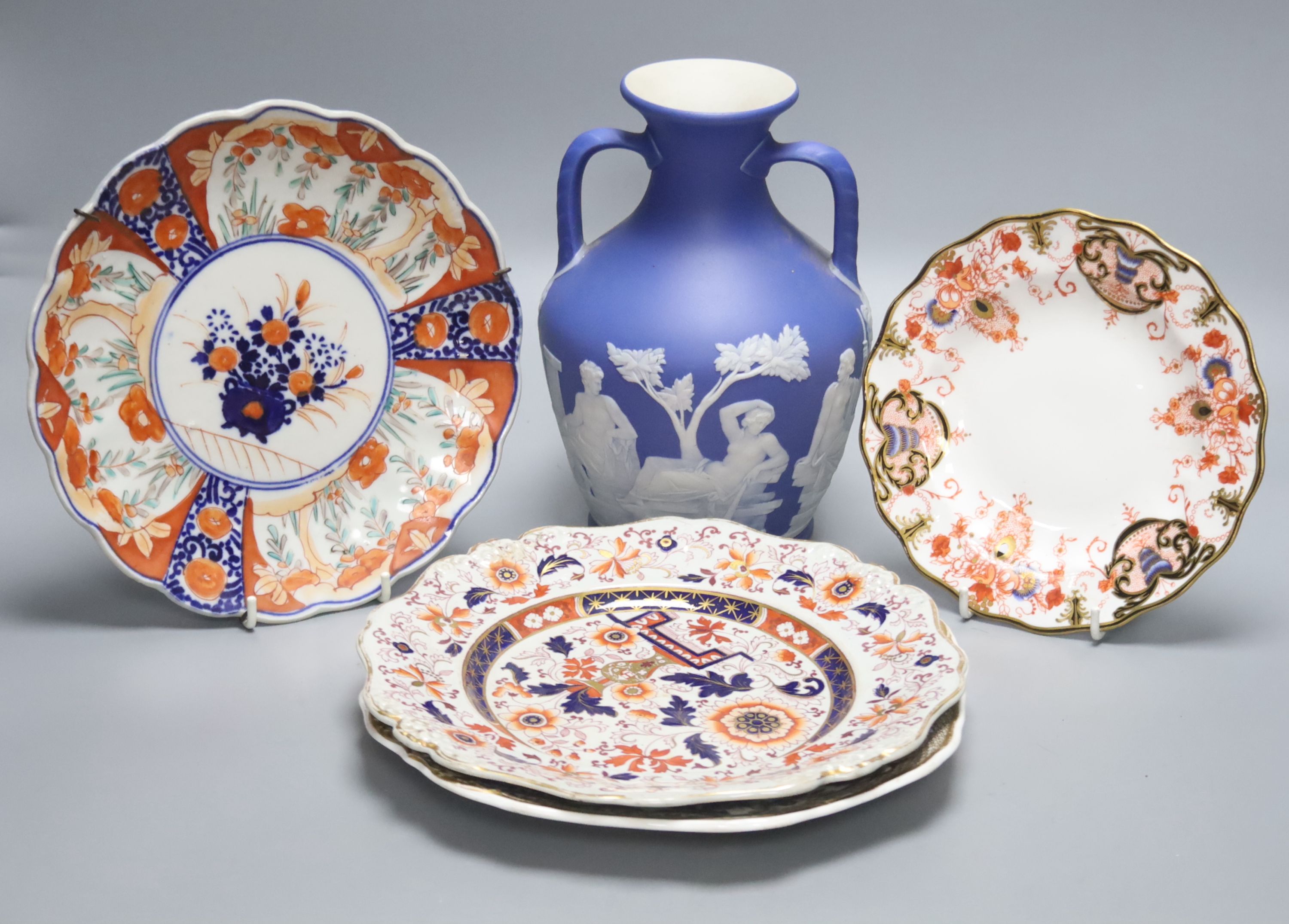 A Wedgwood jasperware Portland vase, 19th century, height 21cm, and four Victorian plates to include Spode and Royal Crown Derby